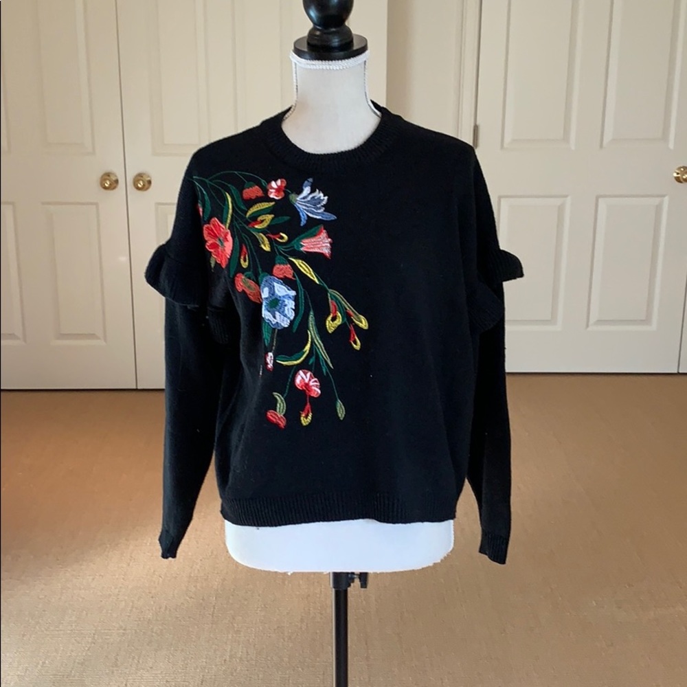 Black embroidered sweater.